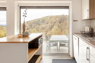 a kitchen with a large glass door leading to a patio at Hillhouse Novo mesto in Novo Mesto