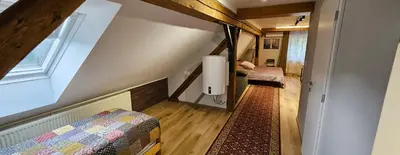 a small room with a bed and a window at Planinski Dom na Travni Gori in Sodražica