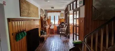 a hallway of a house with a table and chairs at Planinski Dom na Travni Gori in Sodražica