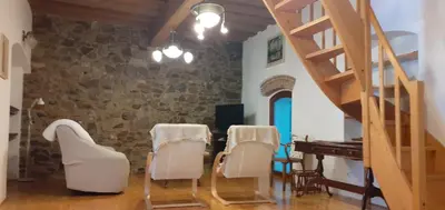 a room with a table and chairs and a piano at Lovely Old City-Center Apartment in Ljubljana