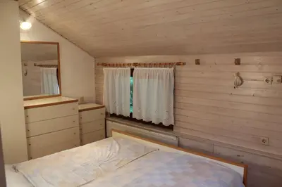 a small bedroom with a bed and a mirror at Lovely Old City-Center Apartment in Ljubljana