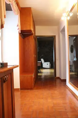 a living room with a wooden floor and a hallway at Lovely Old City-Center Apartment in Ljubljana