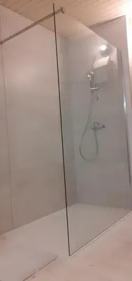a shower with a glass door in a bathroom at Lovely Old City-Center Apartment in Ljubljana