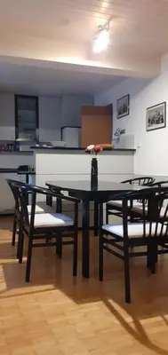 a table and chairs in a room with a kitchen at Lovely Old City-Center Apartment in Ljubljana