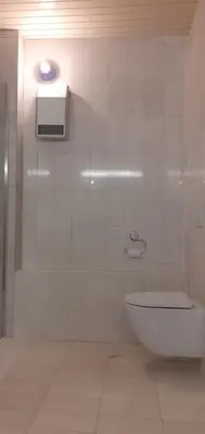 a bathroom with a toilet and a shower with a light at Lovely Old City-Center Apartment in Ljubljana