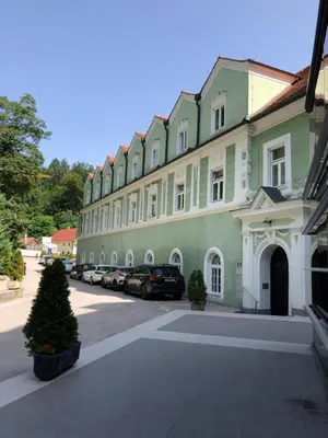 a large building with cars parked in a parking lot at Apartment VilaPark 14 in Rogaška Slatina
