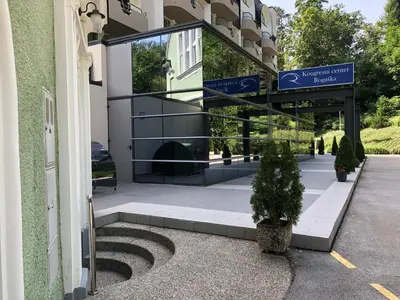 a building with a staircase in front of a building at Apartment VilaPark 14 in Rogaška Slatina