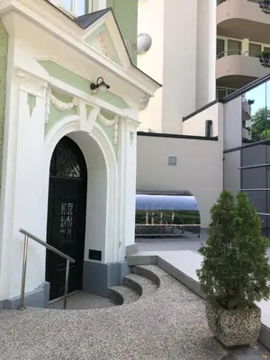 a building with a black door and a bus at Apartment VilaPark 14 in Rogaška Slatina