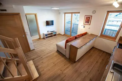 a living room with a couch and a table at Apartments Izvir in Bohinj