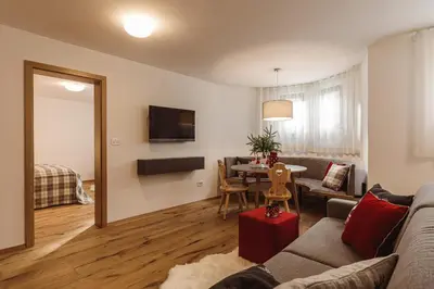 a living room with a couch and a table at Apartments and Rooms Kaja in Kranjska Gora