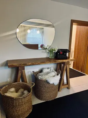 a dressing table with a mirror and two baskets at Apartments and Rooms Kaja in Kranjska Gora
