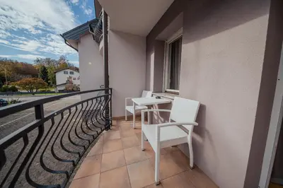 a balcony with two chairs and a table on it at Hotel Maj Inn in Moravske Toplice