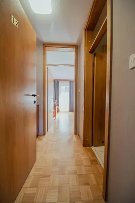 a hallway with wooden floors and a room with a door at Hotel Maj Inn in Moravske Toplice