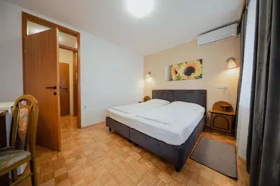 a bedroom with a large bed in a room at Hotel Maj Inn in Moravske Toplice