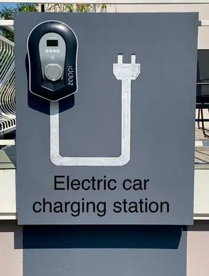 an electric car charging station with an apple watch on it at Hotel Maj Inn in Moravske Toplice