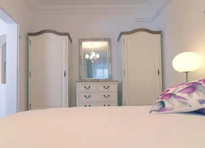 a bedroom with a bed with a pillow and a dresser at City Pearl Apartment in Ljubljana
