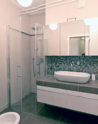 a bathroom with a sink and a glass shower at City Pearl Apartment in Ljubljana