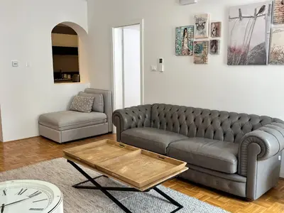 a living room with a couch and a coffee table at City Pearl Apartment in Ljubljana