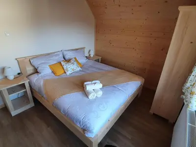 a bedroom with a bed with two towels on it at Apartmaji Pavc in Bohinj
