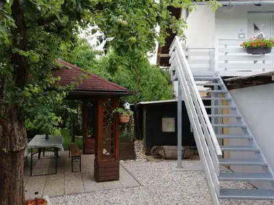 a garden with a staircase and a gazebo at APARTMA CARNICA in Bled