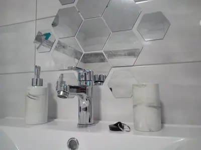 a sink with a faucet and two paper towels at APARTMA CARNICA in Bled