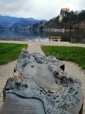 a statue in a park next to a body of water at APARTMA CARNICA in Bled