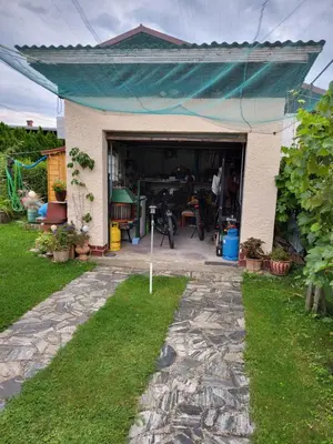 a garage with a blue awning on top of it at Charming house 