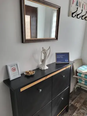 a dresser with a mirror and a plate of food on it at Charming house 