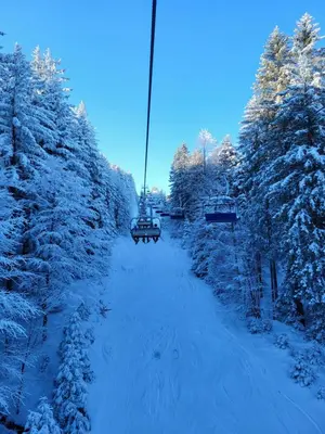 a ski lift going down a snow covered road at Charming house 