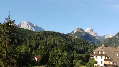 a view of the mountains from a resort at Ajda apartment in Kranjska Gora