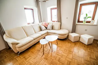 a living room with a couch and a table at Holiday Home Mountain View in Ljubno