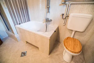 a bathroom with a tub and a toilet and a sink at Holiday Home Mountain View in Ljubno