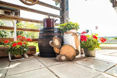 a group of vases and flowers on a table at Holiday Home Mountain View in Ljubno