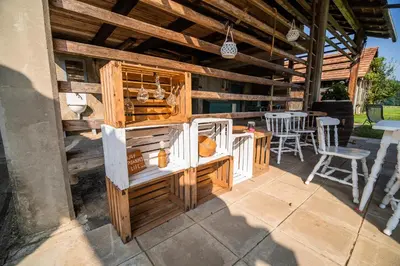 a patio with an outdoor kitchen with a table and chairs at Holiday Home Mountain View in Ljubno
