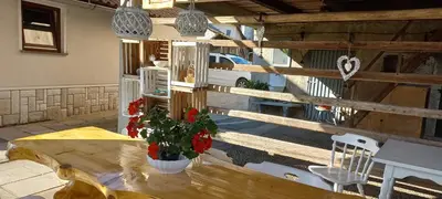 a patio with a wooden table and a fence at Holiday Home Mountain View in Ljubno