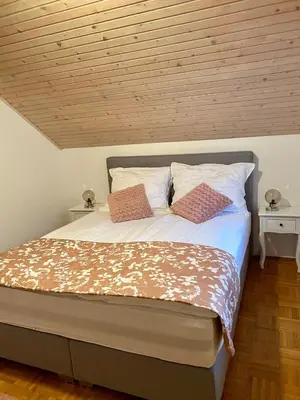 a bedroom with a bed with two pillows on it at Holiday Home Mountain View in Ljubno