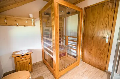 a wooden cabinet in a room with a wooden floor at Country House Sara in Rečica ob Savinji