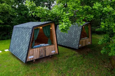 two greenhouses are sitting in the grass at Glamping Health Resort in Kamnik