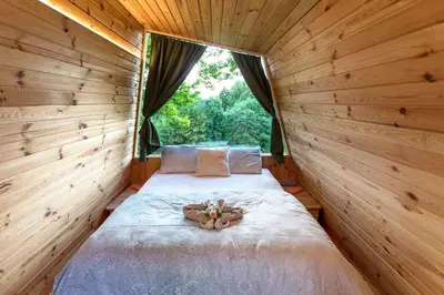 a bedroom with a bed with a teddy bear on it at Glamping Health Resort in Kamnik