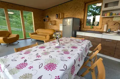 a kitchen with a table with a table cloth with flowers on it at Glamping Health Resort in Kamnik