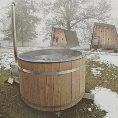 a hot tub in a field in the snow at Glamping Health Resort in Kamnik