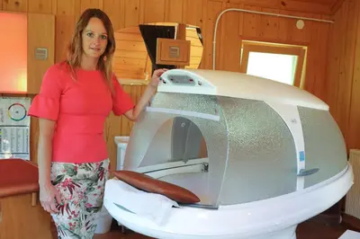 a woman standing in front of a machine at Glamping Health Resort in Kamnik