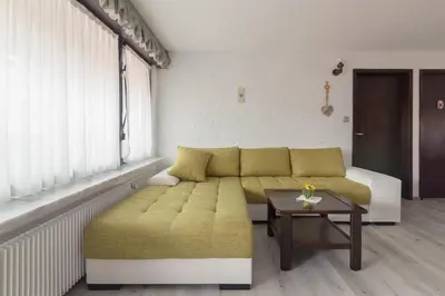 a living room with a couch and a table at Family Apartment NAKITEYA in Ljubljana