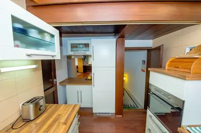 a small kitchen with white cabinets and a stove at Gorgeous Chalet in Bled