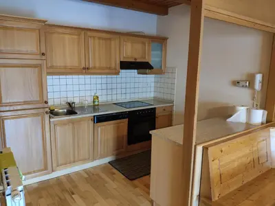 a kitchen with wooden cabinets and a stove top oven at Antela appartments for up to 5 person on Mariborsko Pohorje in Pohorje