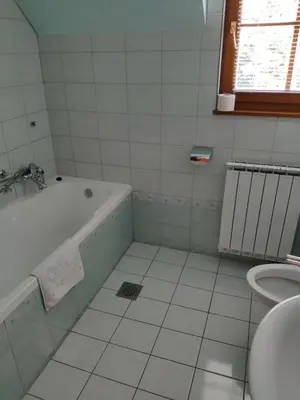 a white bathroom with a tub and a sink at Antela, 142 m2 appartment for 12 person in Mariborsko Pohorje in Pohorje