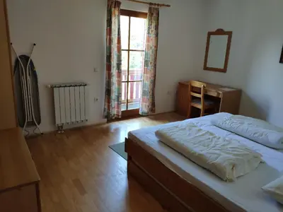 a bedroom with a bed and a desk and a window at Antela, 142 m2 appartment for 12 person in Mariborsko Pohorje in Pohorje