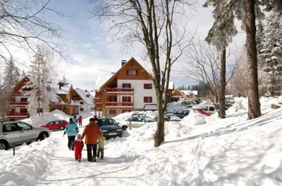 a group of people walking down a snow covered street at Antela, 142 m2 appartment for 12 person in Mariborsko Pohorje in Pohorje