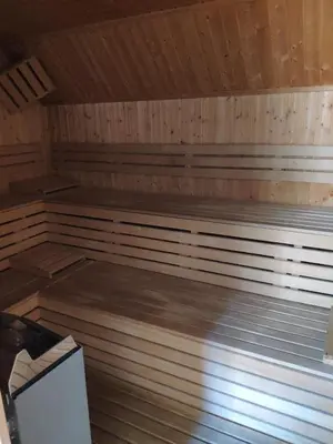 an empty sauna with wooden floors and a wooden ceiling at Antela, 142 m2 appartment for 12 person in Mariborsko Pohorje in Pohorje