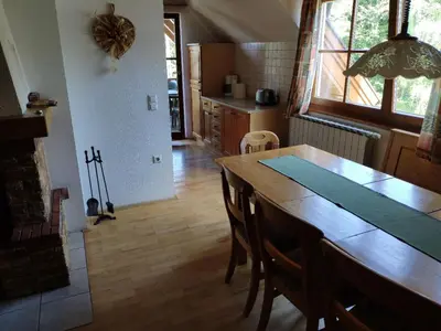 a kitchen with a wooden table and a dining room at Antela, 142 m2 appartment for 12 person in Mariborsko Pohorje in Pohorje